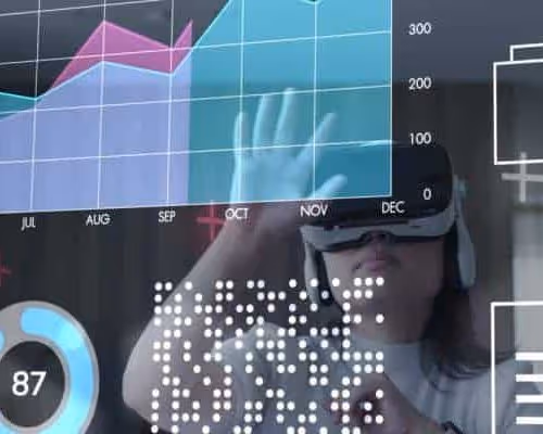 Person wearing virtual reality headset interacting with floating data charts and graphs showing monthly trends and numerical data.