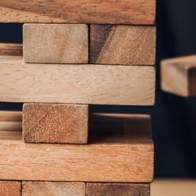 Close-up of stacked wooden blocks arranged in a structure.