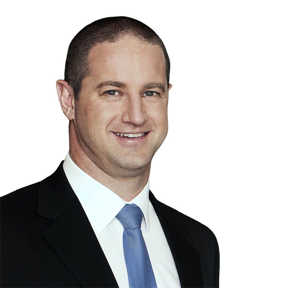 Smiling man wearing a black suit, white shirt, and blue tie against a white background.
